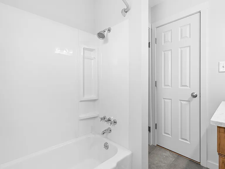 Conveniently located off the main hallway, the second full bathroom is easily accessible from both secondary bedrooms and the main living space.