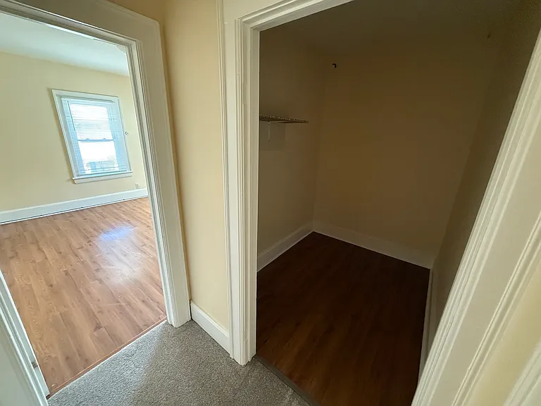A view of the large walk-in closet/storage area, with the entrance to the front bedroom.