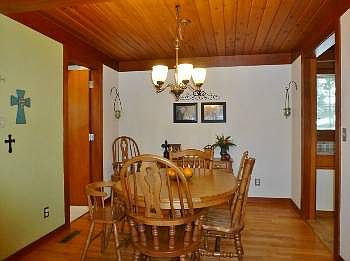 Right off the kitchen is this dining room with original hardwood floors that flow into the living room.