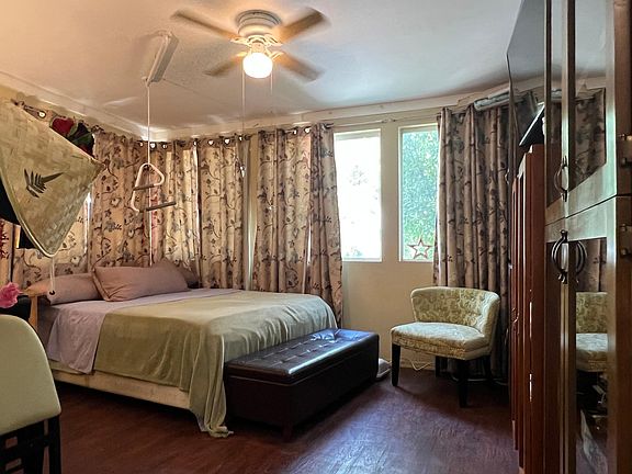 Bed room has a wall of windows to let in air and light - bed is adjustable head and feet up and down -