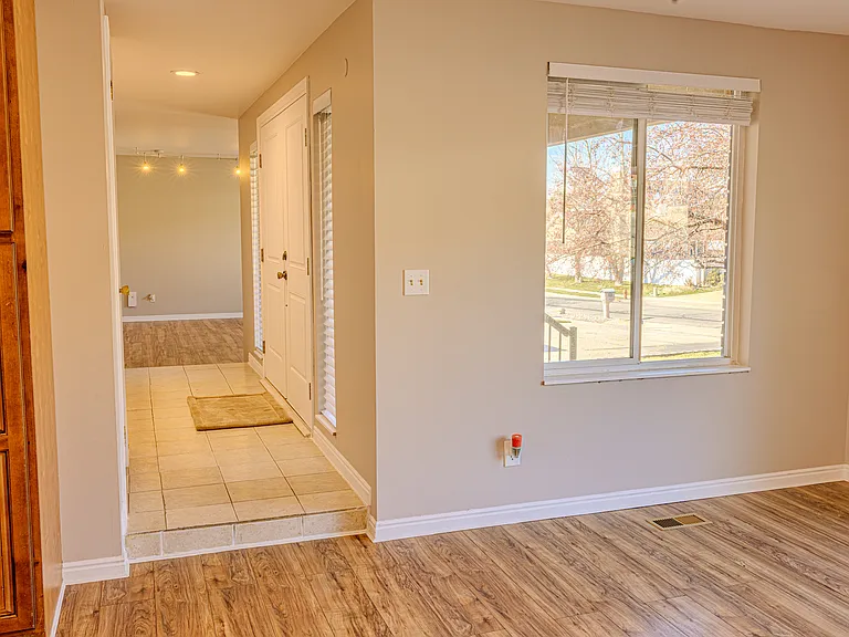 view of the front door from the dining/kitchen area