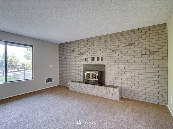 Floor to ceiling brick fireplace makes a nice focal point to the room. 