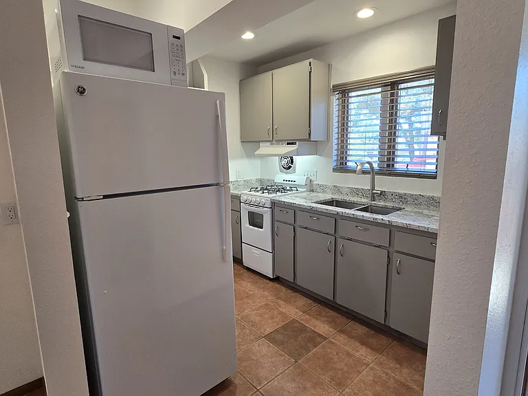 Kitchen area with full size refrigerator and new microwave