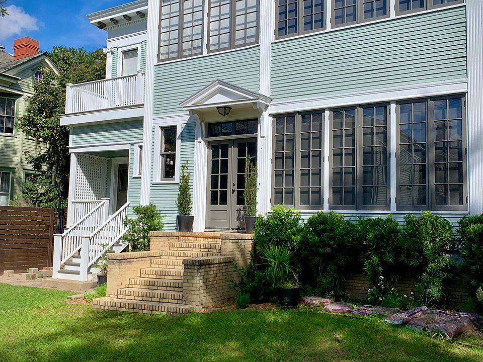 Back of the main house. Apartment entrance is to the left up the stairs with the white wooden railing.