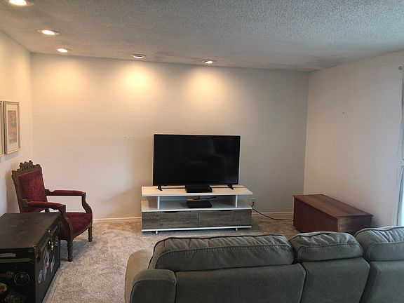 Living area with optionally included furniture (you decide what you want to use). Includes T.V., leather power sofa.