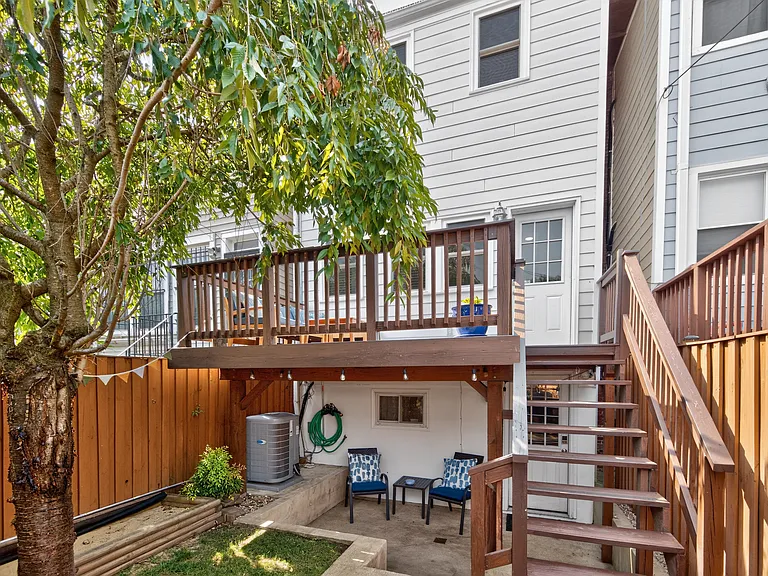 The deck also has a shady sitting area underneath. Note the small sandbox along the fence - great for little kids!