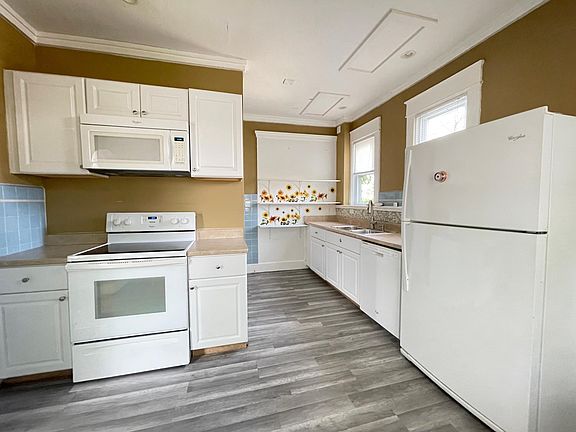 New flooring in kitchen. Sink has a garbage disposal.