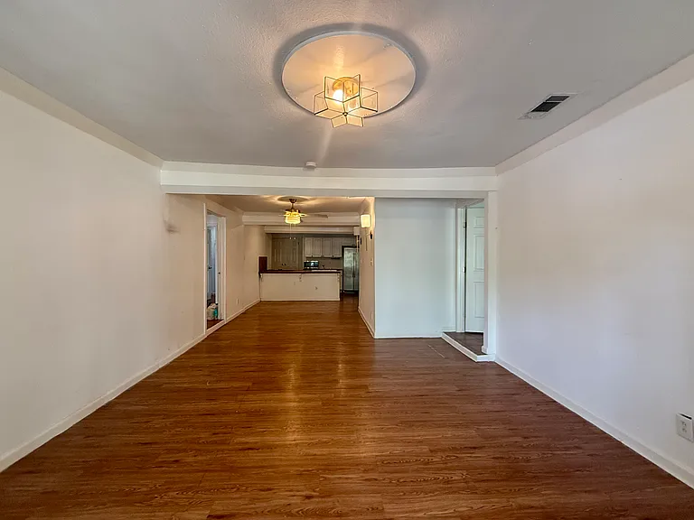 What you see when you open the front door: spacious living and dining areas flow to a lovely kitchen in the rear.
Open door visible on right, up small step, leads to primary suite.
Open door visible on left leads to 2nd bedroom aka "flex suite."