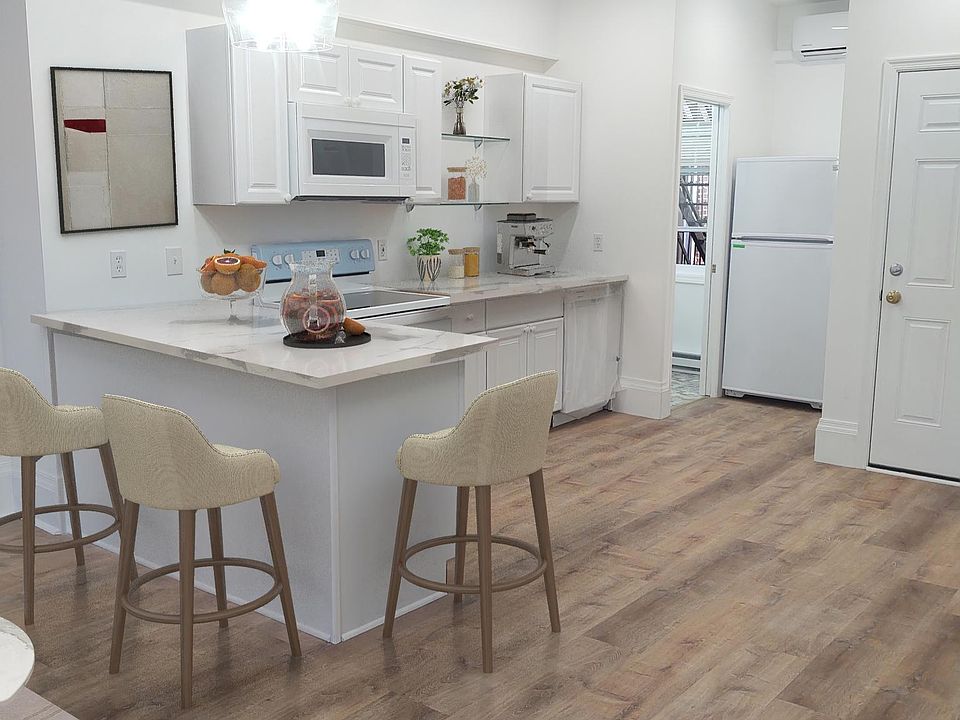 Newly renovated open floor plan kitchen/living room with half-bath on the first floor. stove, microwave, and dishwasher included.