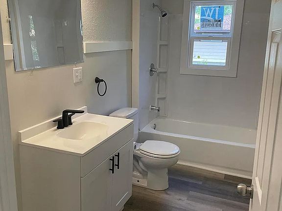 Bathroom with newer vanity, toilet, and shower.
