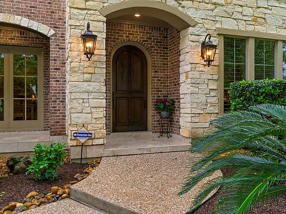 This gorgeous Custom home is warm and inviting before you even walk through the front door. The combination of stone and brick adds beauty and interest.
