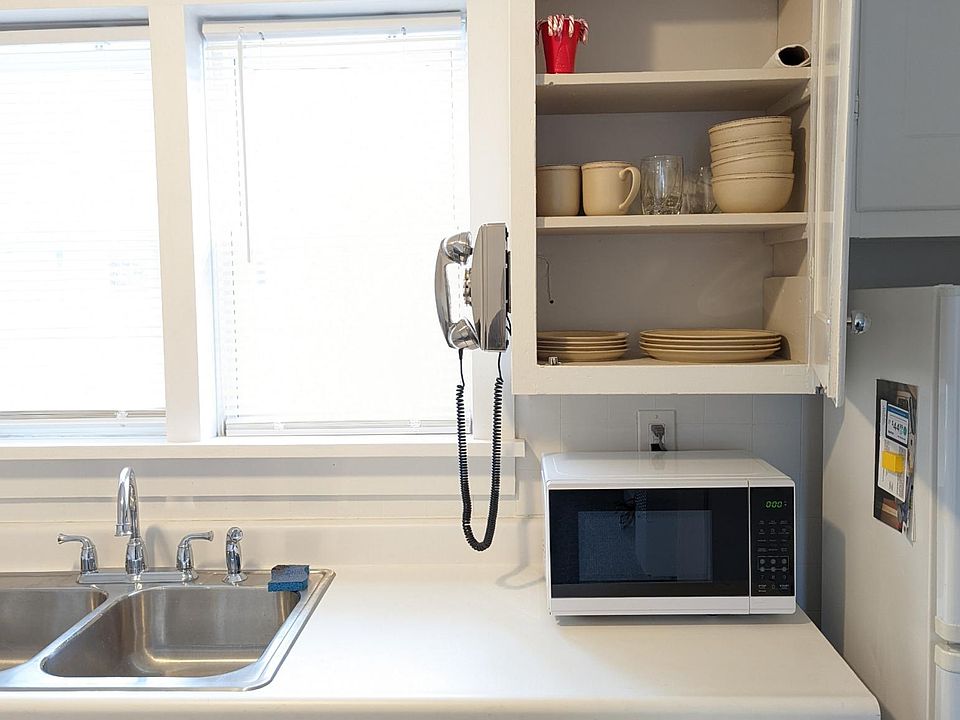 Kitchen stocked with silverware, glassware, and dinnerware