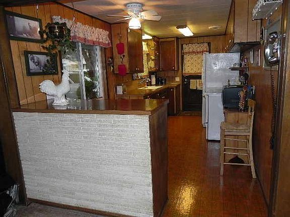 The cheerful kitchen opens to the living room. All appliances remain.