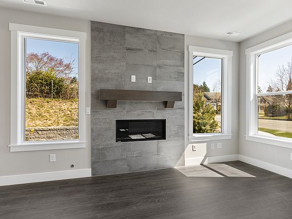 Contemporary gas fireplace with full-height tile and wood mantel