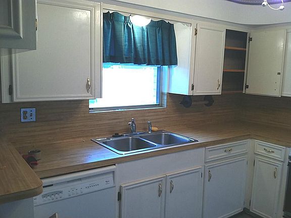 Kitchen window overlooks backyard.