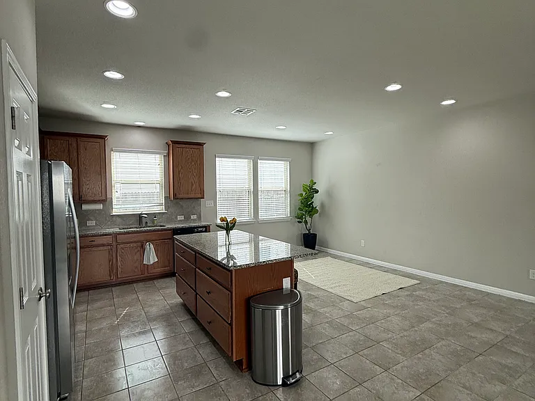 Kitchen with all stainless appliances/ Refrigerator & Island with new hardware on cabinets