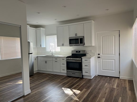 Kitchen and entry door, view from living area.
