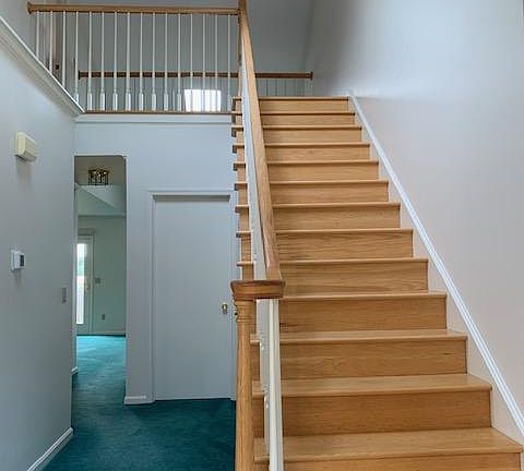 Entry hallway showing door to laundry room and hallway opening to great room.