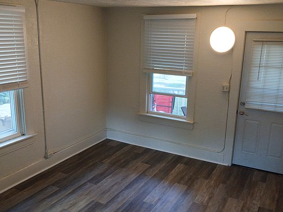 LIVINGROOM, lUXURY VINAL TILE & FAUX WOOD BLINDS.