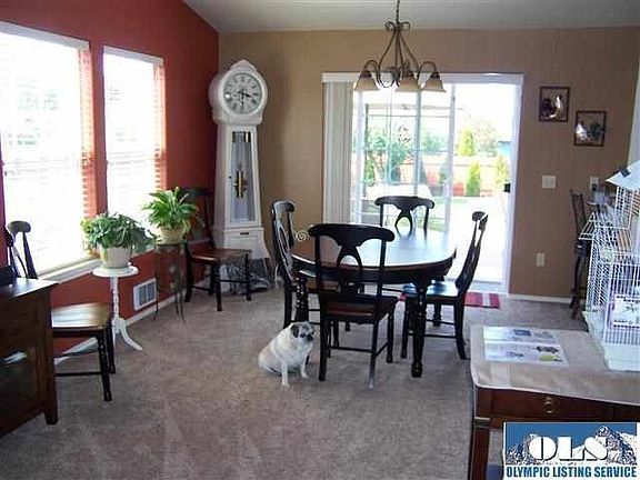 Ok, Fido is stealing the show here but what else does this picture show you? New carpet, new light fixture, a slider to an attractive deck making outdoor or indoor dining convenient.