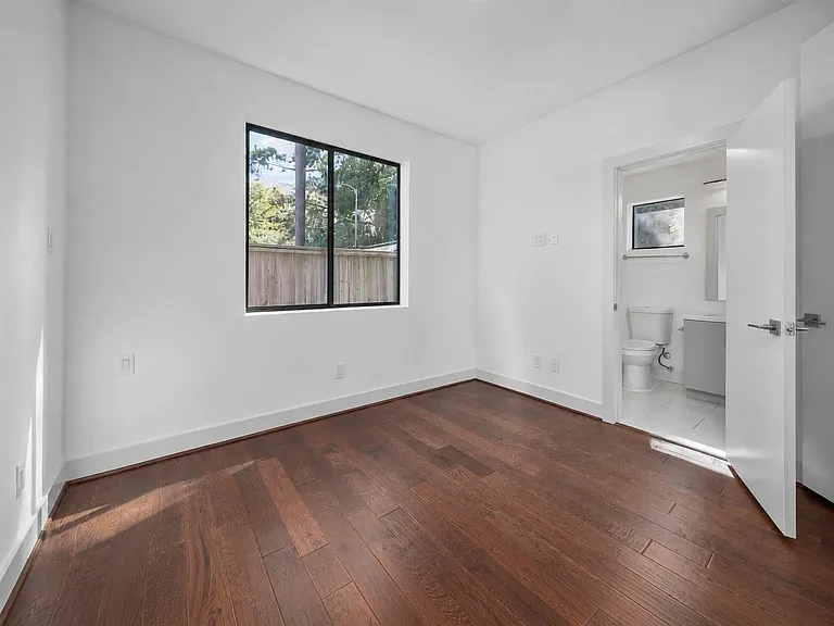 First floor bedrom with ensuite full bathroom. Wood floors and bright windows.