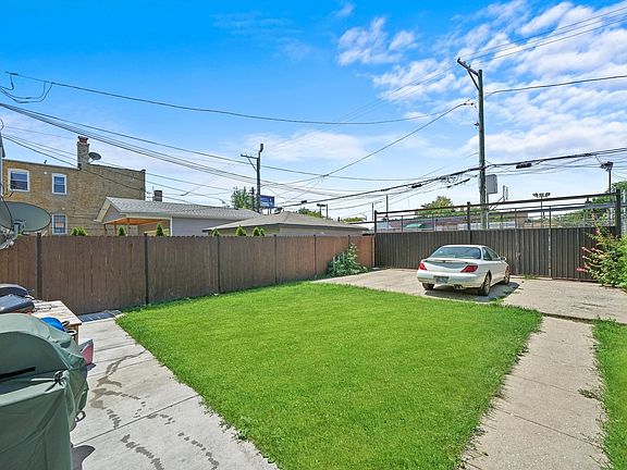 Grassy common area for BBQ's or playing outdoors! Backyard view, fully fenced with motorized gate fo