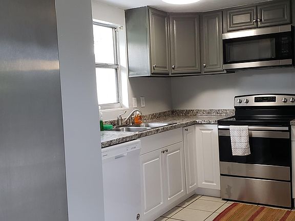Kitchen stove microwave, dishwasher, stainless steel refrigerator
