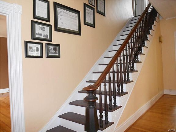 Front entrance leads to a spacious hallway with library to the left and formal living room to the right.