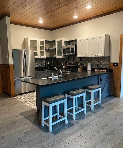 Photo of kitchen area. Island eating area or use the breakfast table behind chairs against the window.