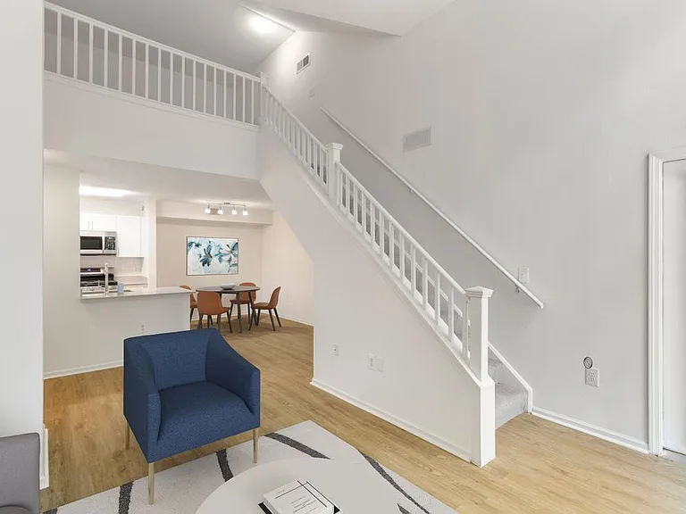 Renovated Package I living and dining area with hard surface flooring. Lofts in select homes.