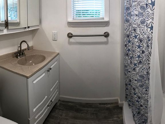New toilet, sink, shower. Plenty of storage in linen closet located just out of the picture frame on the left and a 4 bay mirrored wall "medicine" cabinet.