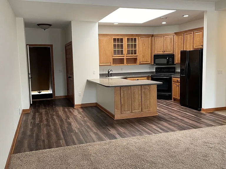 Looking from living area to kitchen and front door.