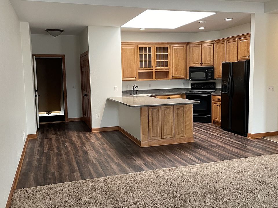 Looking from living area to kitchen and front door.