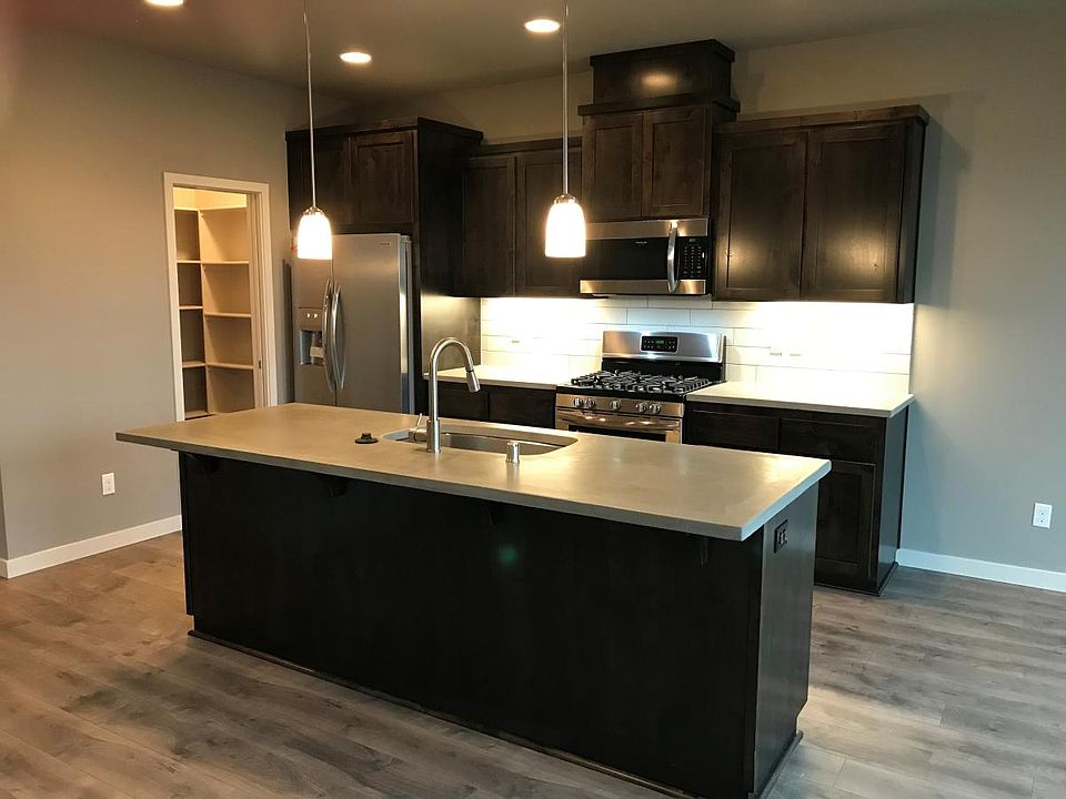 Espresso wood cabinets & concrete countertops