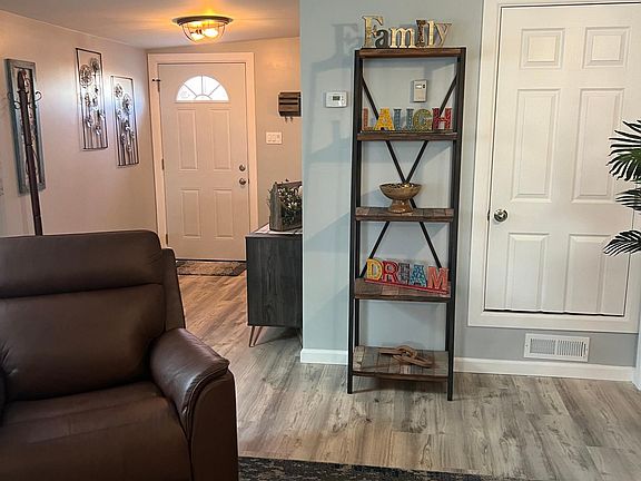 Entry, Den taken from entrance to the hallway that leads to bathroom, bedroom, laundry, dining room and kitchen.