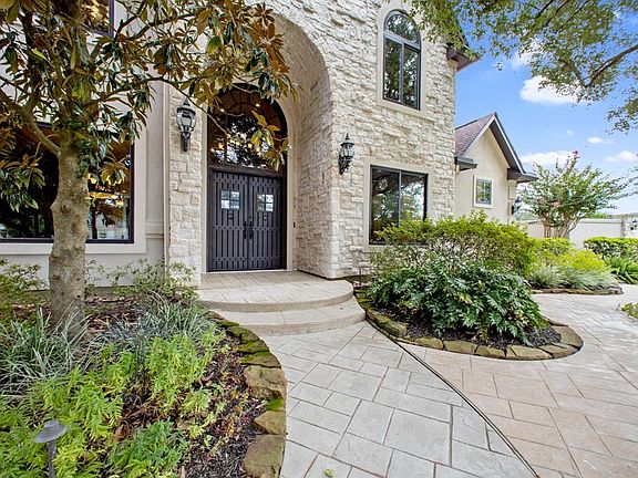 Grand entry ornate steel double door. Pattern concrete driveway, walkway, sidewalks and patios. Landscaped with moss rocks, sprinkler system and drainage. Electrical lighting in beds and trees. Cul-de-sac double lot approximately 25,545 s/f