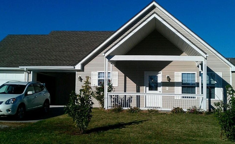 Front view of home. Covered porch.