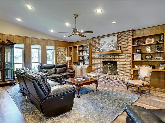 FANTASTIC FAMILY ROOM FEATURES FULL BRICK FP, VALUTED CEILINGS, BUILT-INS, WATERPROOF VINYL PLANK FLOORING.