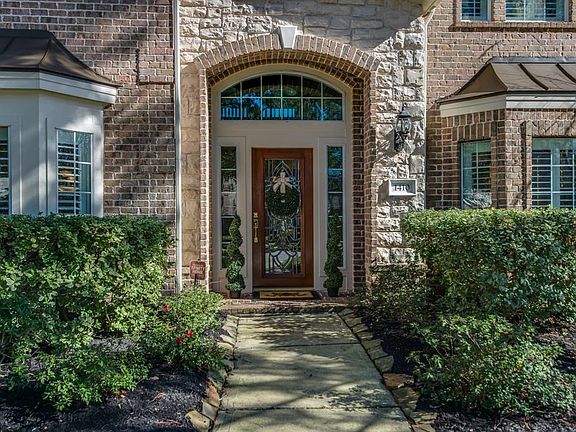 Warm and welcoming stone and brick elevation and entry into a home that offers a simple elegance that is timeless!