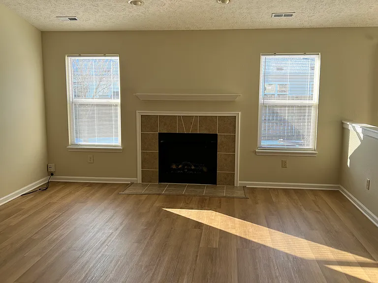 Family Room with vaulted ceilings and electric fireplace.
