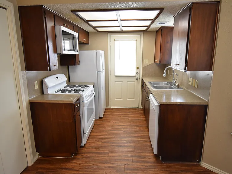 Second view of the kitchen leading to a balcony