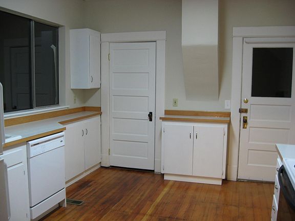 Kitchen with doors to laundry room and porch.