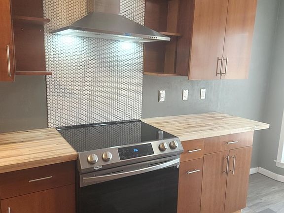 Kitchen with oven and induction stove.