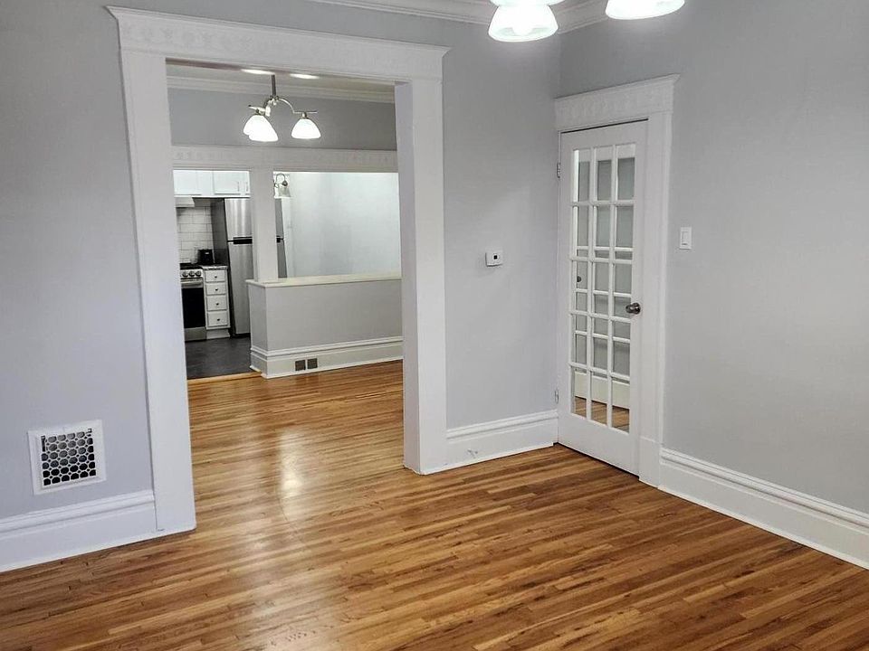 Front room looking into middle room with beautiful hardwood floors.
