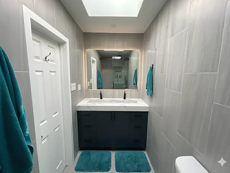 Master bathroom featuring a custom modern vanity with sleek finishes and ample storage.