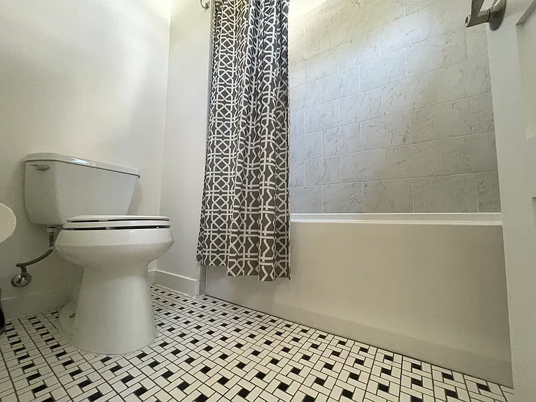Deep bathtub for luxurious baths or shower use.