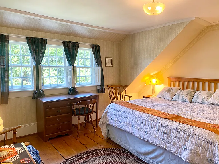 The is the main bedroom with king bed and closet, bureau and desk