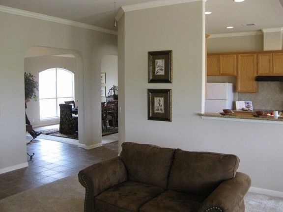 Open floorplan with lots of crown molding and decorative archways