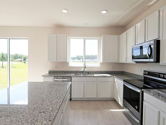 kitchen with a view. Brand new premium appliances. 400CFM exhaust built in microwave. Granite counters.