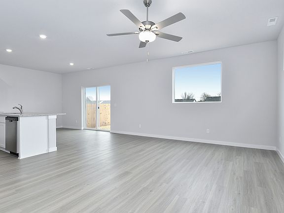 The family room is spacious with a ceiling fan.